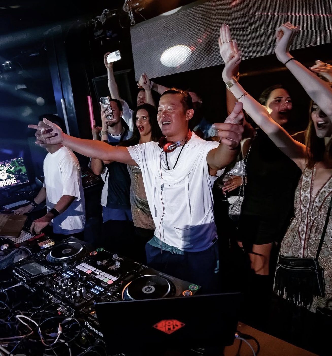 DJ Boramy on the decks with the crowd behind him
