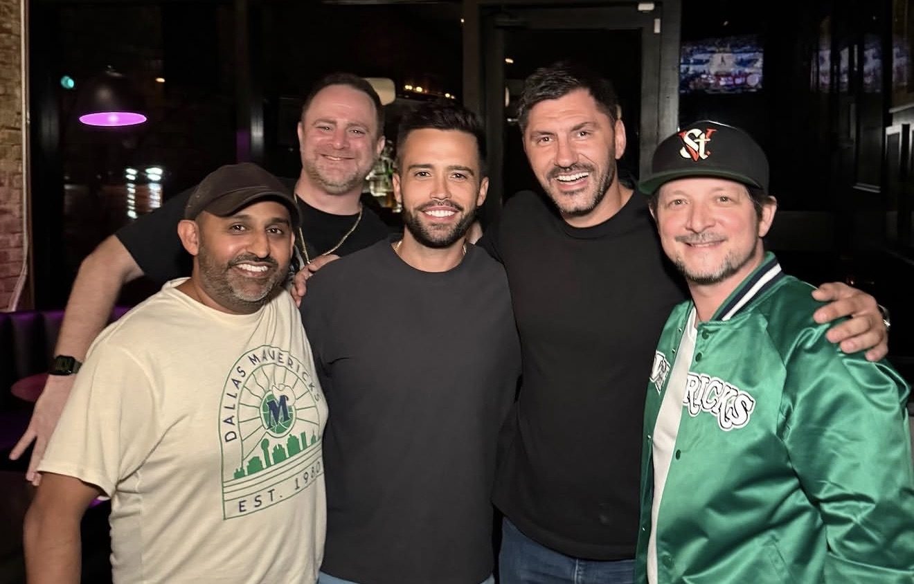Five members arm in arm on a night out.