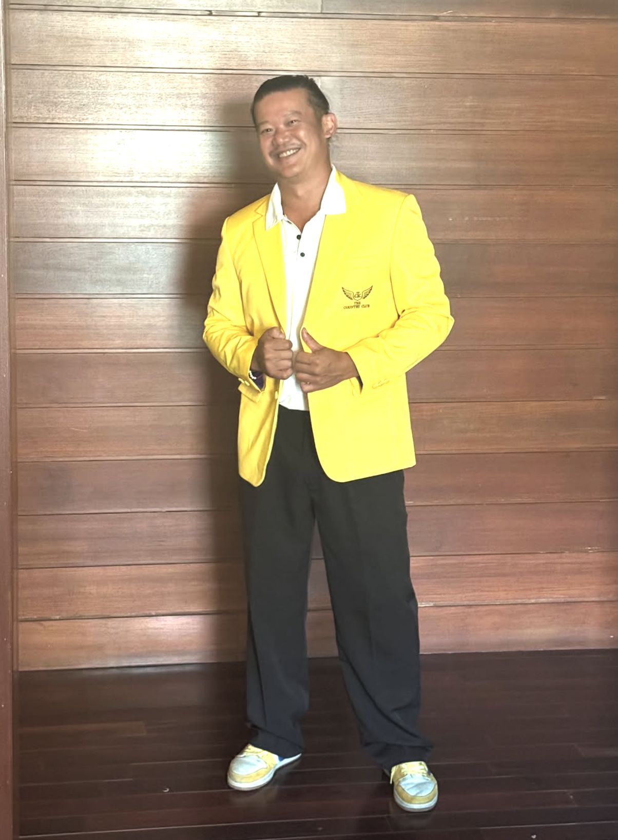 DJ Boramy smiling in the c1ub's yellow jacket