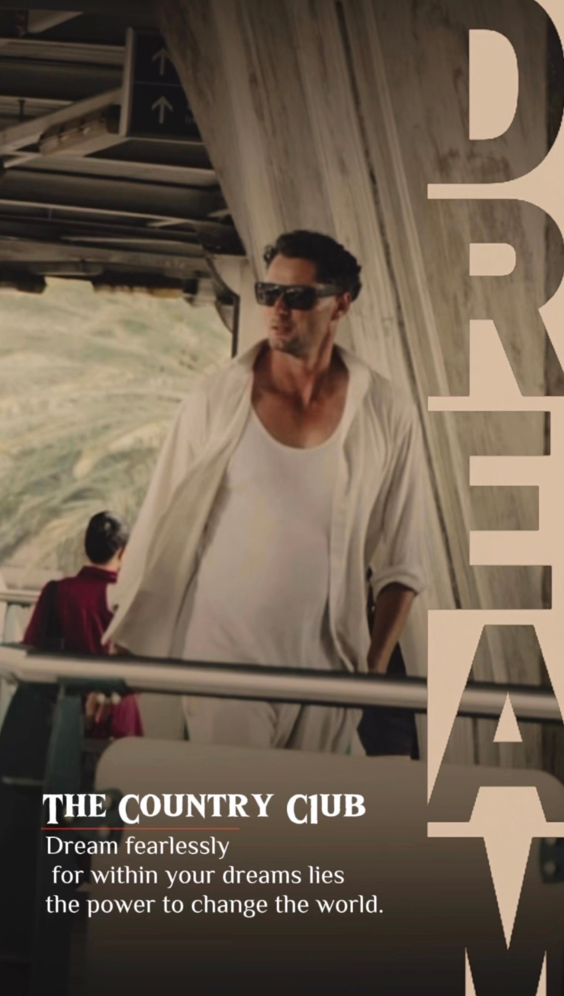 Cameron Tennant on a ferry deck in white linen, with the word DREAM set vertically and The Country C1ub mark reading: Dream fearlessly, for within your dreams lies the power to change the world