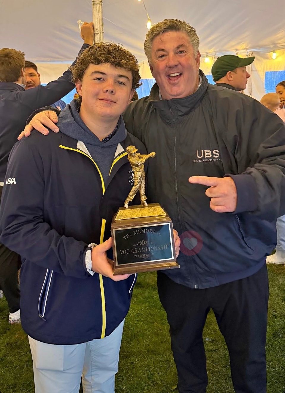 Craig O'Callaghan with his son Gus, trophy in hand, 2026