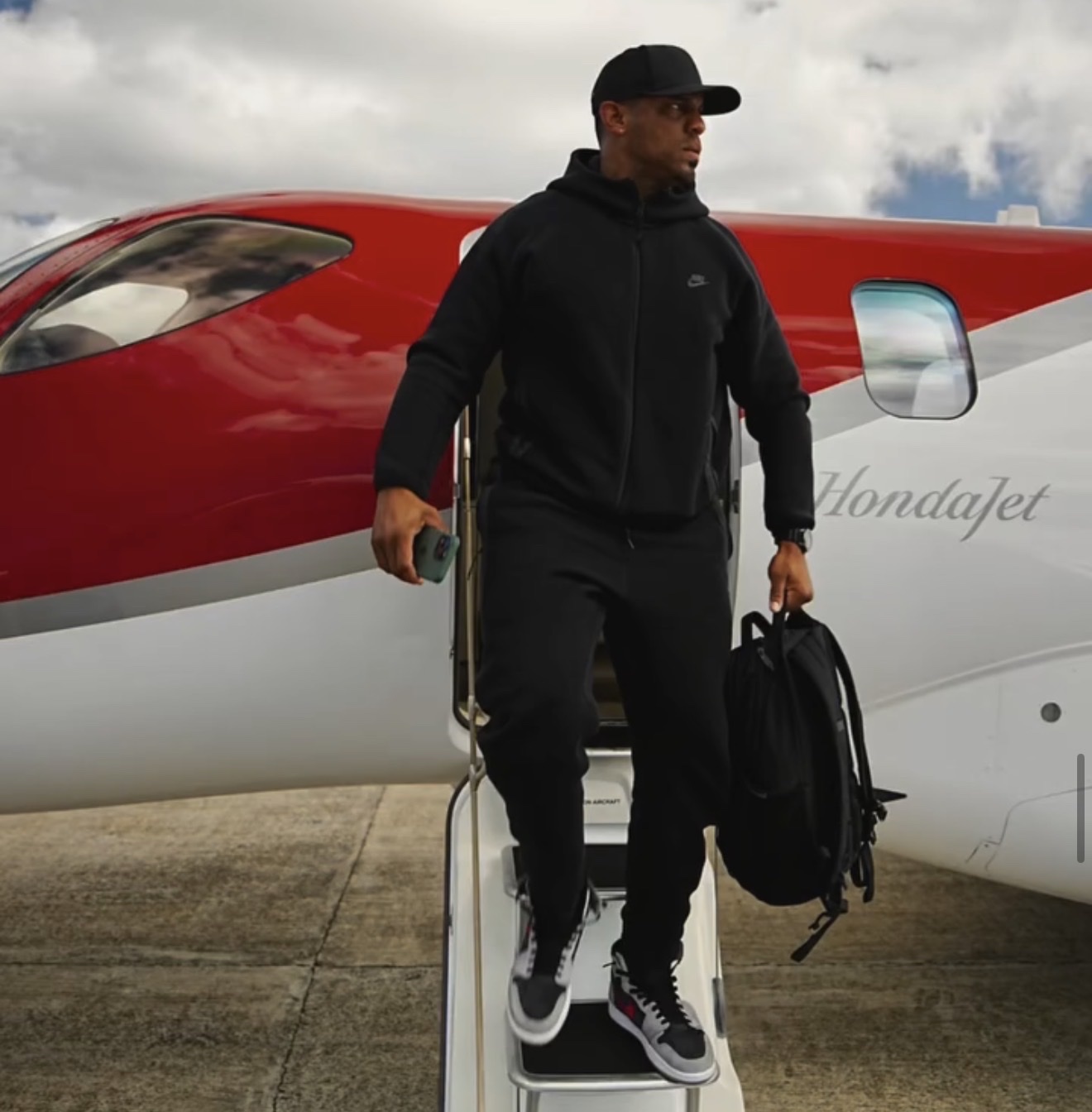 Piki stepping off a HondaJet — wherever the client goes, he's already there