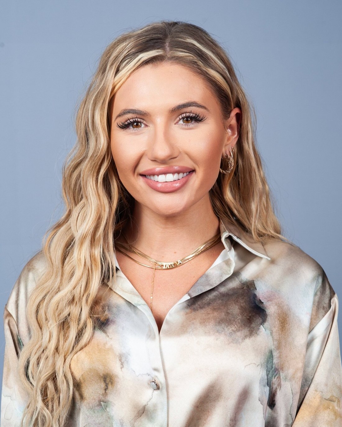 Zianna Marie in an ivory and gold silk blouse with gold jewelry, luminous portrait