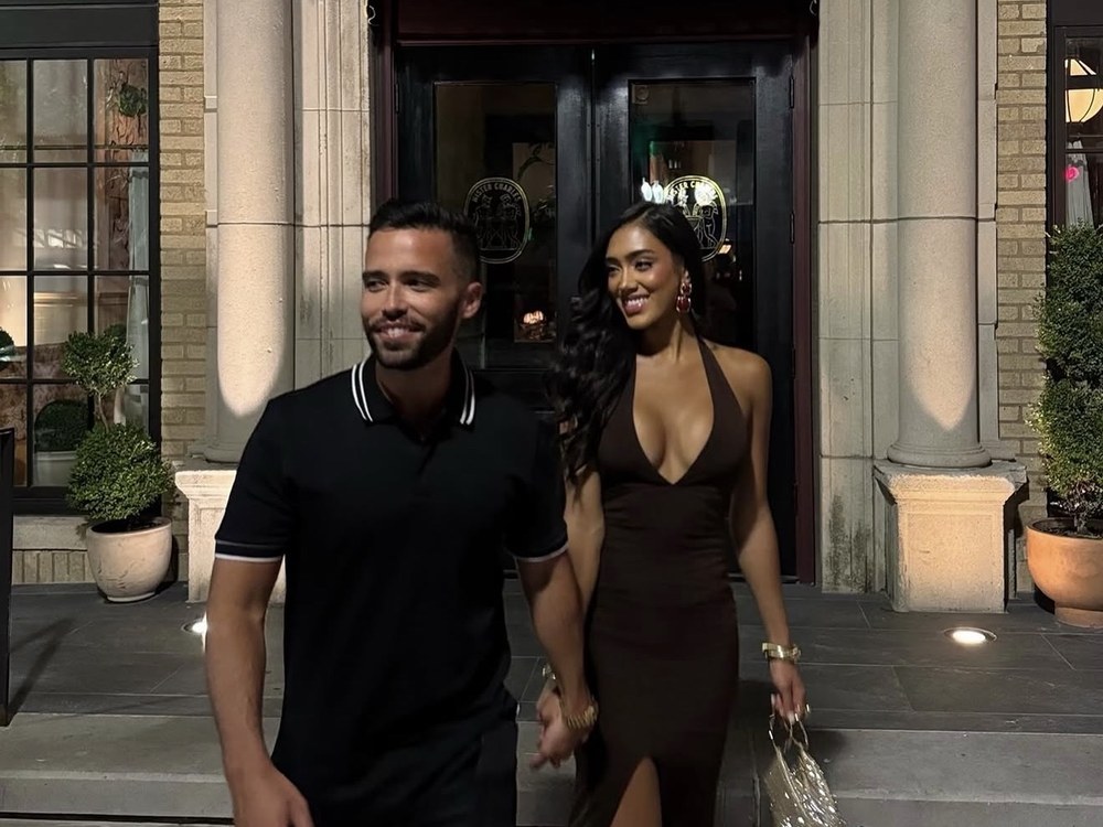 Two members walking out of dinner together at night.