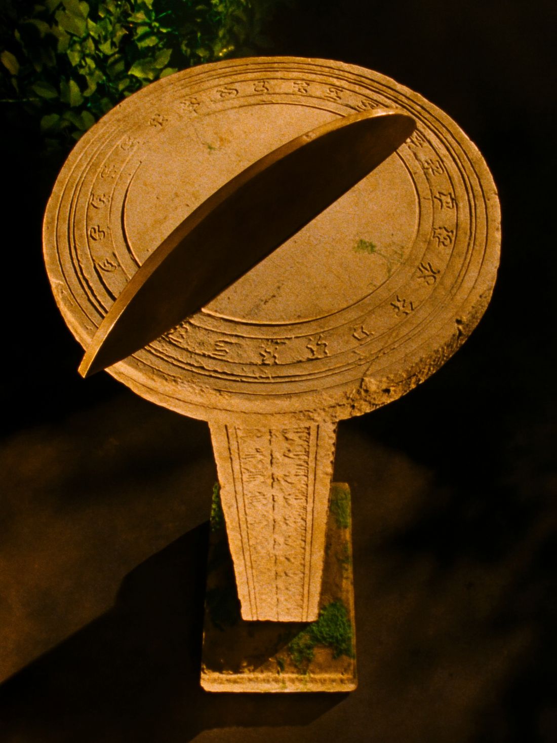 An ancient stone sundial catching a blade of morning light