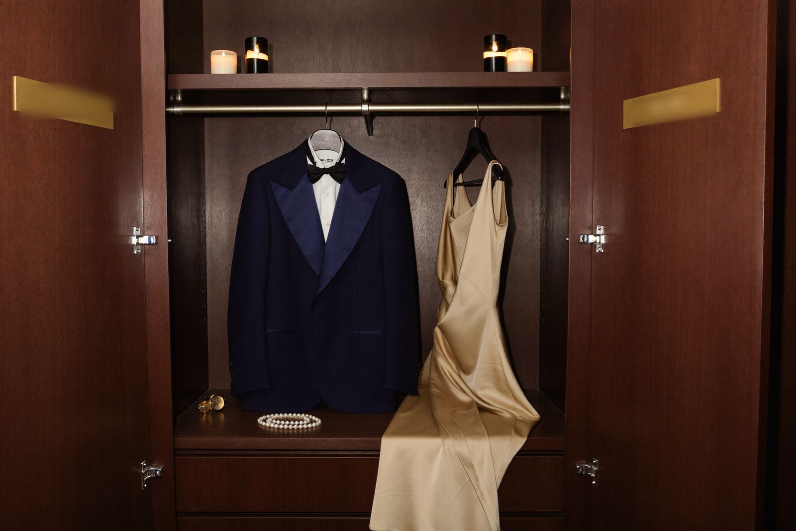 A locker door with a brass nameplate, half open, warm light inside