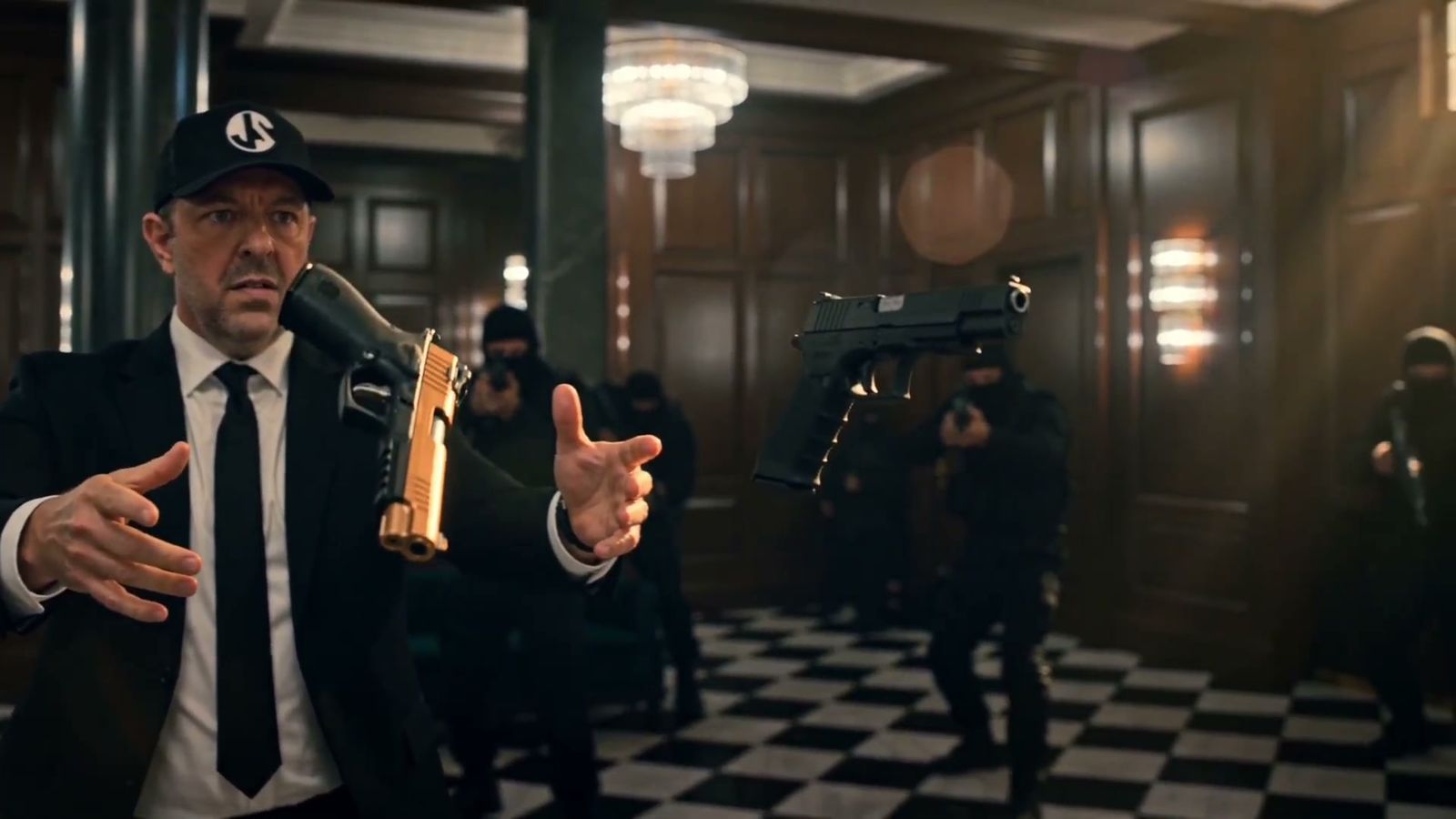 Jarrod catching a gold pistol out of the air in the grand hall